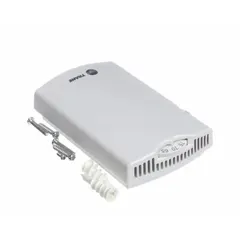 Temperature control device with integrated 3-speed fan switch for HVAC systems. Used to regulate room temperature and fan speed in residential or commercial zones. Replacement part for TRANE equipment.