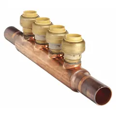 This copper inline manifold has 2 inlets and 4 outlets, with inlet size 3/4 in and outlet size 1/2 in. Overall height is 2.52 in. Used in plumbing and heating systems to distribute water from supply lines to multiple branch lines.