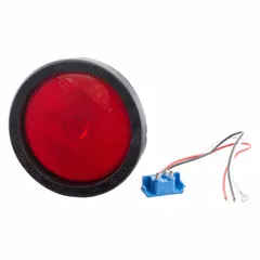 Red round incandescent stop light with 4 5/16 in overall diameter. Features a pigtail electrical connection and grommet mount for permanent installation. Complies with FMVSS 108 standards. Used on vehicles to indicate braking.