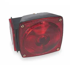 Red rectangular incandescent trailer light with bracket mount and wire harness connection. Includes license plate bracket for removable installation. Complies with FMVSS 108. Overall height 4 1/2 in. Suitable for rear lighting on trailers.