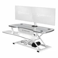 This electronic standing desk converter from VERSADESK features a white wood desktop measuring 40 inches wide by 24 inches deep. It allows users to alternate between sitting and standing positions at a workstation, providing a stable surface for monitors and peripherals in office or home environments