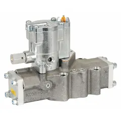 Four-way, two-position directional control valve with single solenoid, plug-in design, and spring return. Features internal pilot operation, locking manual override, and female 1 in NPT connections. Used in pneumatic systems for switching airflow in industrial automation and material handling applications.