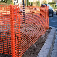 This polyethylene barrier fence is 4 ft high and 250 ft long, colored orange for high visibility. It is used for temporary perimeter control, hazard marking, and crowd management at construction and industrial sites.