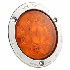 LED turn signal light with amber lens and round shape, 5 9/16 in overall diameter. Features permanent grommet mount and pigtail electrical connection. Complies with FMVSS 108 standards. Used on trucks, trailers, and heavy equipment for turn and hazard signaling.