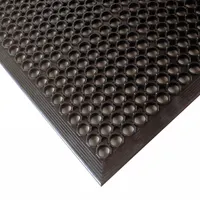 This standard drainage mat features a raised-ring design with beveled edges, constructed from black natural rubber. At 1/2 in thick and non-reversible, it provides a slip-resistant surface for industrial environments where drainage and standing comfort are required
