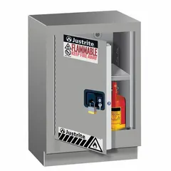 Steel flammable storage cabinet with manual door, stationary design, and silver finish. Measures 35 3/4 inches high, 24 inches wide, and 21 5/8 inches deep. Suitable for storing flammable liquids on or under benches in laboratory and industrial settings.