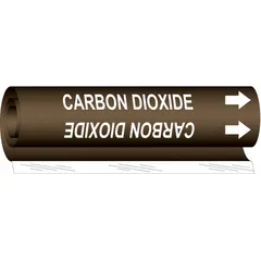 Wrap-around pipe marker for identifying carbon dioxide piping. Brown background with white legend text reading 'Carbon Dioxide' and directional arrows. Fits pipe outer diameters from 1/2 to 1-3/8 inches. Single marker included.