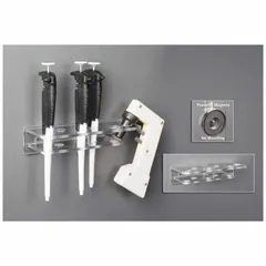 Wall-mounted pipette holder made of clear PETG. Overall height 2 1/4 in, length 3 5/8 in. Designed for organizing pipettes and pipette aids in laboratory or industrial settings.