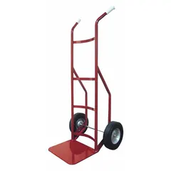 This hand truck features a steel frame with a red finish and dual handles for balanced lifting. Pneumatic 10-inch wheels provide cushioning and traction on uneven surfaces. Suitable for moving heavy loads in warehouses, factories, and loading docks.