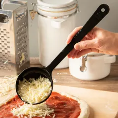 Solid acetal portion control spoon with a 6 oz capacity, designed for consistent serving sizes in commercial foodservice. Black color, NSF certified for sanitation. Suitable for portioning solid foods in cafeterias, restaurants, and institutional kitchens.