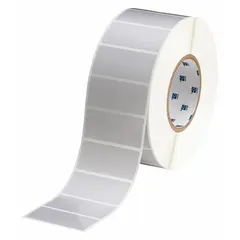 Gray polyester precut label roll measuring 1 1/4 in x 2 3/4 in, with 3000 labels per roll. Compatible with THT printer series. Used for industrial identification, asset tracking, and safety labeling in environments requiring chemical and abrasion resistance.