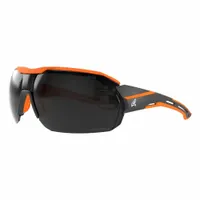 These padded comfort-fit safety glasses feature a half-frame Vapor Shield design with a black/orange frame and smoke lens. The lens has Advanced Anti-Fog properties for clear vision. The glasses are metal detectable and X-ray detectable, suitable for environments requiring contamination control such as food processing, pharmaceutical, and cleanroom settings