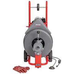 Corded drum machine for clearing blockages in 3 in to 8 in diameter pipes. Features automatic feed operation and a 5/8 in cable. Includes gloves for operator use. Model 41977.