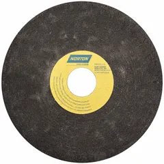 This NORTON Type 1 nonreinforced cut-off wheel measures 7 inches in diameter, 1/16 inch thick, with a 1-1/4 inch arbor hole. It features a 57A60-OE7 specification and an O wheel hardness. Designed for stationary toolroom machines, it is used for cutting ferrous metals, producing clean, burr-free cuts with minimal heat buildup.