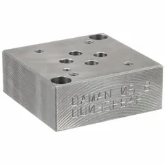 Valve subplate for mounting D03 NFPA size hydraulic valves. Ductile iron body with NPT port connections. Overall height 2.5 in. Used in fluid power systems to provide a secure mounting interface and porting for directional control valves.
