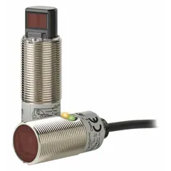 Cylindrical photoelectric sensor with M18 threaded brass body and built-in 4-pin M12 connector. PNP output, operates on 10-30V DC. Suitable for object detection in industrial automation applications such as packaging, material handling, and assembly lines.