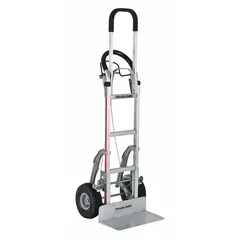 This MAGLINER load-control hand truck features a flow-back handle design for controlled tilting. The silver aluminum frame is lightweight and corrosion-resistant. Flat-free tires eliminate punctures and maintenance. With a 60-inch handle height, it is suited for moving boxes, appliances, and equipment in warehouses, factories, and delivery settings.