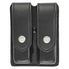 This duty equipment pouch is constructed from synthetic leather in a plain black finish. It measures 5 3/4 inches by 1 5/16 inches and secures with a snap closure. Designed for carrying a magazine on a belt or duty rig, it provides quick access for security or tactical applications.