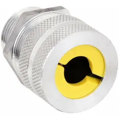 Straight metallic cable grip with 1 in MNPT box connection, accommodating cord diameters from 0.63 in to 0.75 in. Aluminum body in silver finish with yellow color-coded grommet. Rated for Class II, Division 1 & 2 hazardous locations, suitable for use in environments such as grain elevators or coal handling plants.