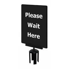 Black acrylic sign displaying 'Please Wait Here' message. Includes mounting adapter for use with Tensabarrier posts. Measures 11 inches long by 7 inches wide. Suitable for queue management and pedestrian guidance in public venues.