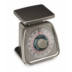 Mechanical dial scale for weighing ingredients in commercial kitchens, bakeries, and food service operations. Features a 5 1/4 in wide by 6 in deep weighing surface and 7 1/4 in overall height. Provides portion control and recipe measurement.