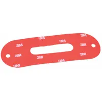 Red plastic mounting tape for securing vehicle light mounts and brackets. Measures 6 1/2 in length, 2 1/8 in height, and 1/32 in width. Suitable for use in automotive lighting installations where a flat adhesive bond is required