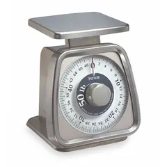 Mechanical dial food scale with a weighing surface 6 in wide and 5 1/4 in deep, overall height 7 1/4 in. No batteries required. Suitable for weighing ingredients in commercial kitchens, bakeries, and food service operations.