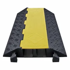 This hinged-cover cable ramp from ELECTRIDUCT provides two channels for routing cables and hoses across roadways, construction sites, and event venues. Constructed of rubber in a yellow/black color scheme, it measures 24 inches wide, 4 inches high, and 35 3/4 inches long, with a load capacity of 24,000 lb per axle. The hinged design allows easy access to cables while protecting them from heavy vehicle traffic.