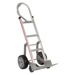 This MAGLINER hand truck features a single-loop, silver aluminum frame with flat-free tires and an ergonomic tilt-back design. It is used for moving boxes, appliances, and equipment in warehouses, delivery routes, and industrial facilities. The 500 lb capacity suits heavy-duty daily use on loading docks and uneven surfaces.