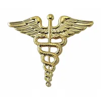 Gold-colored metal rank insignia for medical officer, 1 inch size, with clutch pin attachment. Used on uniform caps, collars, or lapels to denote rank. Pack of 1