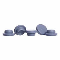 Synthetic rubber stopper made of gray chlorobutyl, complying with USP <381> standards. Stopper size 20 with 20 mm top diameter, 7.6 mm bottom diameter, and 6.9 mm overall height. Used to seal laboratory flasks and vials.
