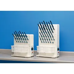 Benchtop electric drying rack constructed of ABS plastic. Includes two baskets and 5-inch pegs. Overall dimensions: 16 3/4 in length, 7 1/2 in width. Used in laboratory and industrial settings for drying glassware, instruments, and small parts.
