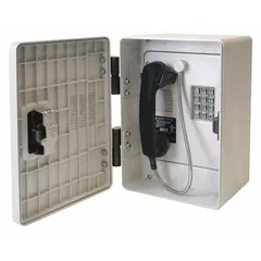 Surface-mountable PSTN telephone with gray Hytrel plastic housing, water-resistant construction, and a latching keylock door. Designed for hazardous areas requiring reliable voice communication in outdoor commercial settings.