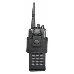This duty equipment pouch is constructed from black nylon ballistic material. It measures 5 3/4 inches by 3 3/4 inches and secures with a snap closure. Designed for carrying communication devices such as radios or phones in professional security and public safety settings.