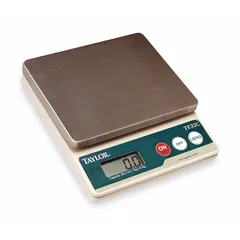 Compact food scale with a 5 3/8-inch square weighing surface and 1 3/8-inch overall height. Provides readability of 0.1 oz or 1 g for portion control and ingredient weighing in commercial kitchens and food service operations.