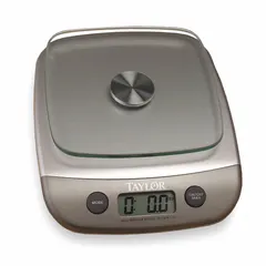 Compact food scale with a 6-inch square weighing surface and LCD display. Provides readability of 1 gram or 0.1 ounce for precise portion and ingredient measurement. Suitable for countertop use in kitchens or food-service settings. Not IP rated; avoid moisture exposure.