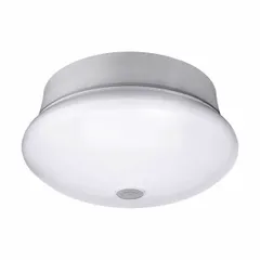 This ceiling-mount LED retrofit spin light features a white plastic housing and acrylic shade lens. It delivers 830 lumens at 10.5 watts with a color temperature of 5000K, operating on 120V AC. The integrated motion sensor enables automatic on/off operation, suitable for indoor areas such as hallways, closets, and utility rooms.