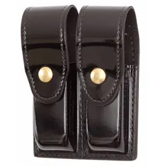 This duty equipment pouch is constructed from synthetic polymer with a high-gloss finish and features a snap closure. Designed for carrying magazines, it is suitable for use on belts or duty rigs in security and tactical applications.