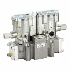 Four-way, two-position directional control valve with double solenoid actuation and plug-in design. Ports are female 3/8 in NPT. Features internal pilot, solenoid return, and locking manual override. Used in industrial pneumatic systems to direct compressed air to actuators or cylinders.