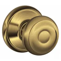 Passage knob lockset for interior doors where no locking is required. Features a Georgian style with a brass finish. Suitable for applications such as closets, hallways, or other areas needing free egress without a locking mechanism