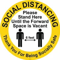 This 17 in x 17 in vinyl floor sign features a white background and adhesive mounting for placement on floors. It is used to mark standing positions, supporting spacing protocols in work areas, queues, and common zones. The sign is 0.012 in thick and suitable for indoor use
