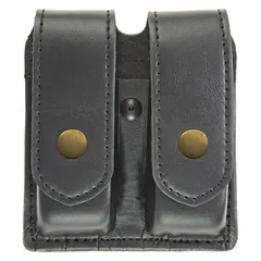 This duty equipment pouch is constructed from black synthetic leather with a plain finish. It measures 5 1/2 inches by 1 3/8 inches and secures contents with a snap closure. Commonly used for carrying spare magazines or similar small items on a belt or vest.