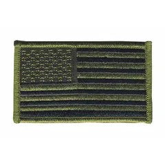 Sew-on embroidered emblem featuring a U.S. Flag design in black and green on a plastic base. Measures 3 3/8 in x 2 in. Suitable for attaching to uniforms, tactical gear, bags, or apparel for identification or display.