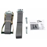 Nylon ratchet strap with floor-mount plate for securing large equipment to the floor. Rated for 4000 lb capacity, 2 in x 180 in strap. Used in industrial, warehouse, and data center settings to anchor machinery or cabinets against movement