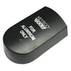 Rubber-faced auto body dolly for shaping and smoothing metal panels. Measures 5 in long, 3 in wide, 1 1/2 in high. The rubber face provides a non-marring backing for hammer work on curved surfaces such as fenders and quarter panels.