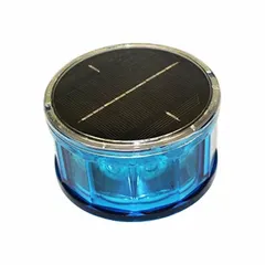 Solar-powered flashing light with a blue lens. Overall height 2 5/16 in, overall diameter 4 3/16 in. Used for safety marking and hazard warning in industrial environments such as rail yards, construction sites, and road work zones.