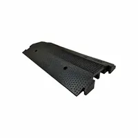 This 2-channel drop-over cable ramp is made of black rubber and features a T-shaped connection style. It supports a load capacity of 4,000 lb per axle. Designed for protecting cables and hoses in high-traffic areas where vehicles and pedestrians cross