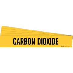 Yellow adhesive pipe marker with black legend text reading 'Carbon Dioxide'. Designed for pipes with outer diameter 2-1/2 to 7-7/8 inches. Sold in a 5-pack without directional arrows. Used to identify carbon dioxide lines in industrial piping systems.