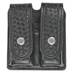 Duty equipment pouch constructed from black synthetic leather with a basket weave finish. Measures 5 1/2 inches by 1 3/8 inches. Designed for carrying a magazine on a belt or duty rig.