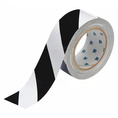 This general purpose floor marking tape features a striped black/white pattern for high-visibility warning. It is made of polyester with a thickness of 8 mil and measures 2 inches wide by 100 feet long. The tape has no legend and is suitable for marking aisles, hazards, and work zones in industrial facilities.